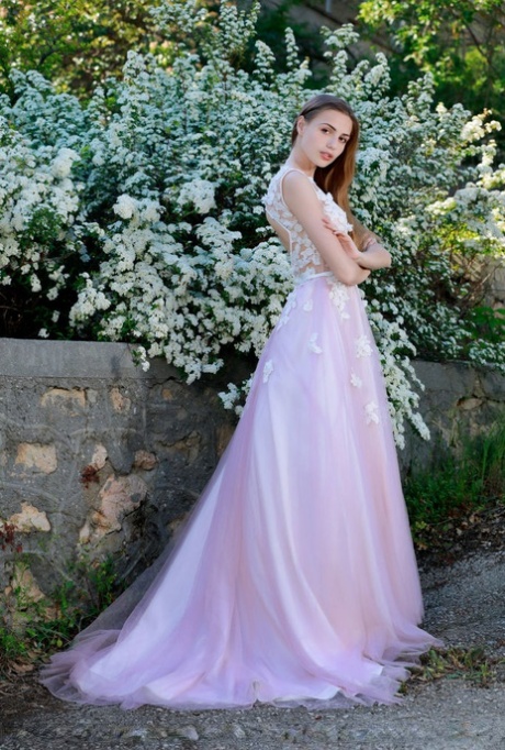 Beautiful girl Elle Tan slips off wedding dress to pose nude in garden
