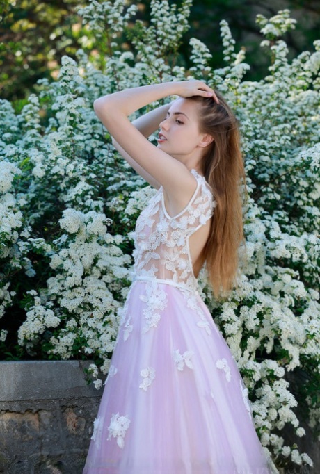 Beautiful girl Elle Tan slips off wedding dress to pose nude in garden