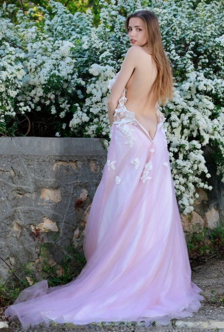Beautiful girl Elle Tan slips off wedding dress to pose nude in garden