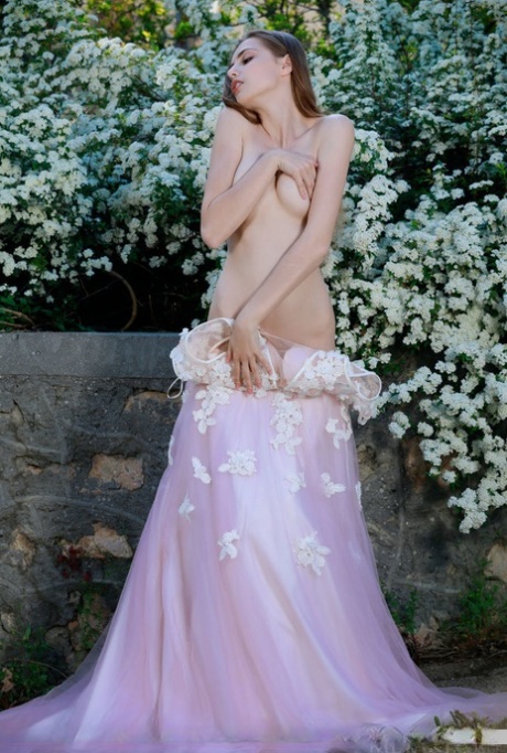 Beautiful girl Elle Tan slips off wedding dress to pose nude in garden