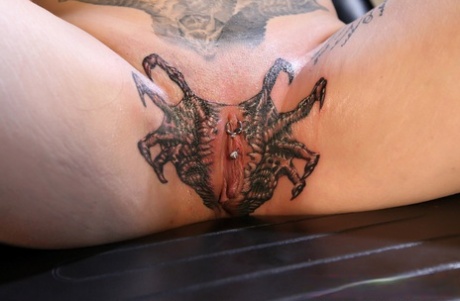 Dark-haired girl Misha Montana spreads her legs while having her cunt tattooed