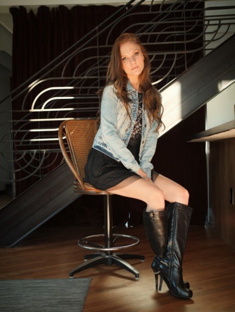 Sexy redhead Sydney Shafer gets naked on a flight of stairs in black boots
