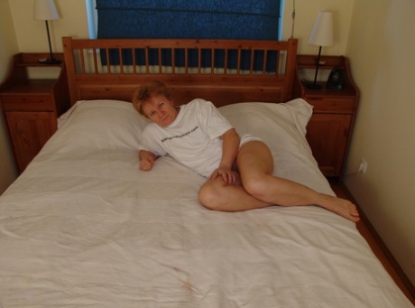 Granny with a big booty Rozalia masturbates with a ripe banana on her bed