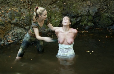 Busty virgin gets schooled by a blonde lezdom in outdoor water bondage action