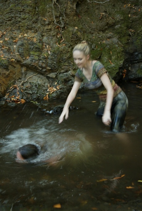 Busty virgin gets schooled by a blonde lezdom in outdoor water bondage action