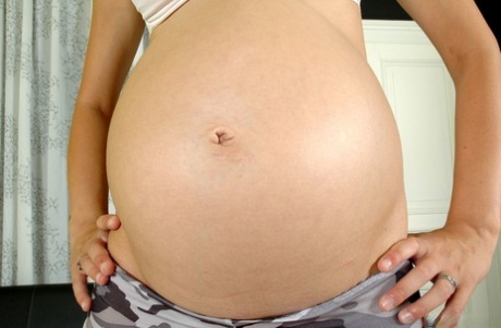 Pregnant amateur Charlotte Pelucci reveals her big belly and milks her tits