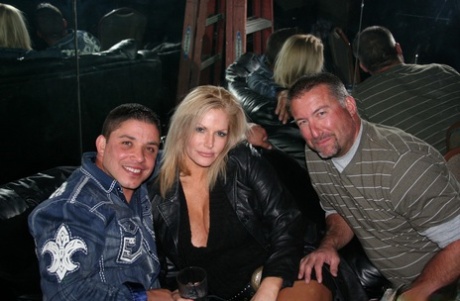 Blonde swinger with huge juggs and her friends having fun in the night club